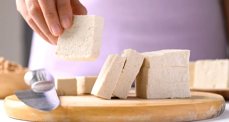 Fresh tofu blocks on cutting board