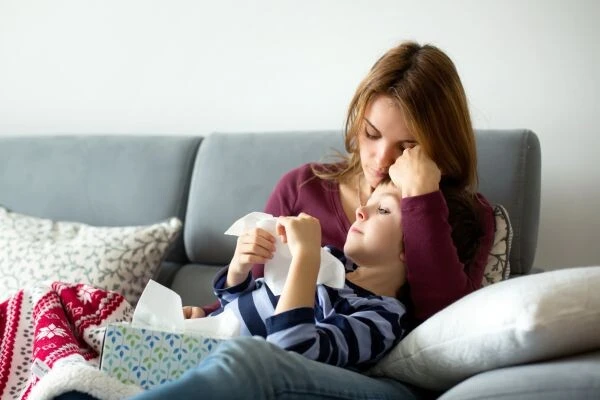 Mother comforting sick child